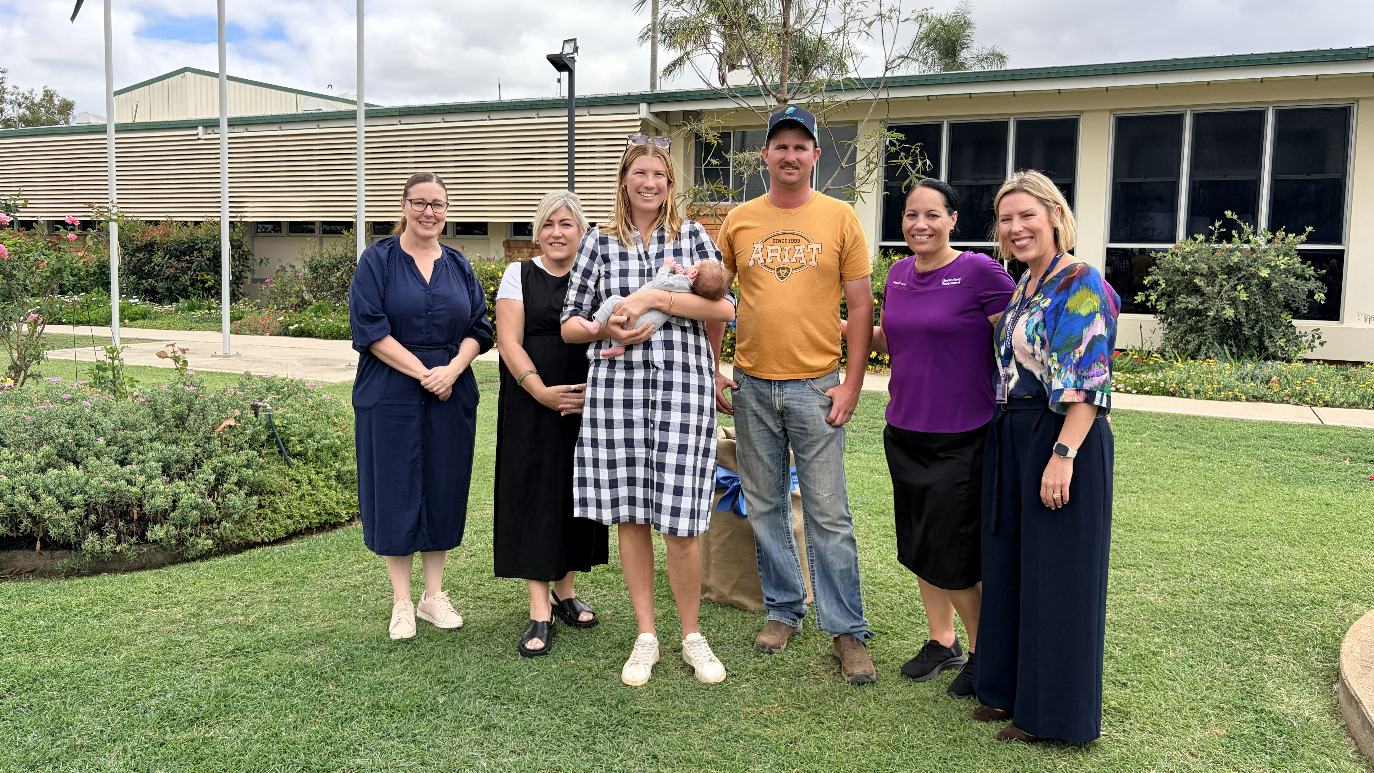 Central Queensland Health Staff with Biloela mum dad and baby, in front of Biloela Hospital