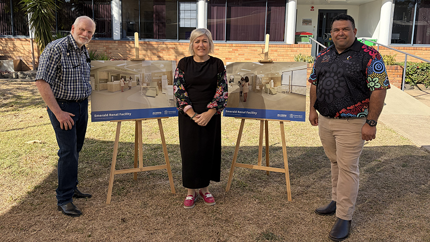 Three people standing in front of Emerald Hospital near artist impressions of the new renal facility.